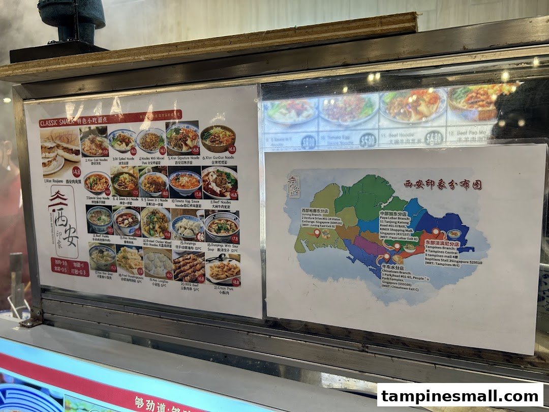 A display counter showcasing Xian Cuisine's menu with food photos, prices, and a map of their Singapore branches.