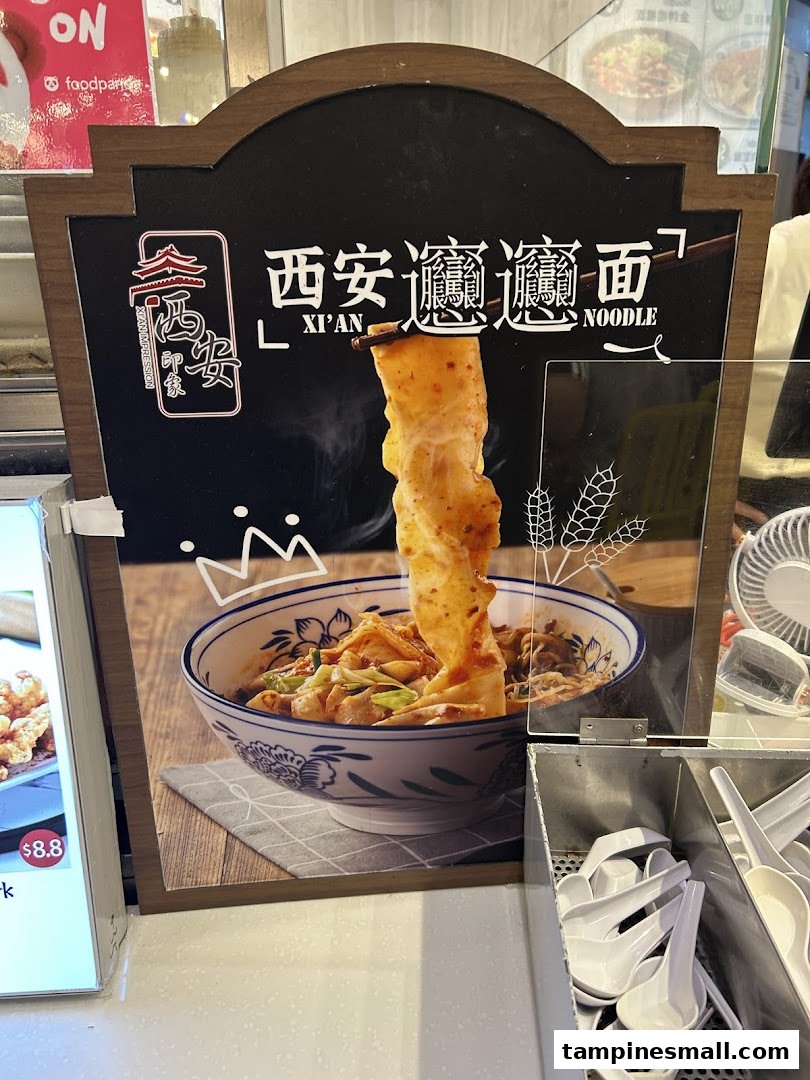 A display board showcasing a steaming bowl of Xi'an Biang Biang noodles with chopsticks.