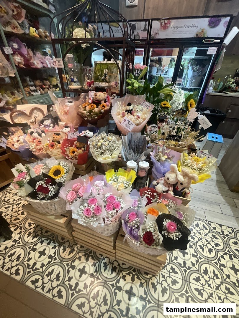 A vibrant display of various flower bouquets and arrangements, including roses, sunflowers, and plush toys, inside Xpressflower.