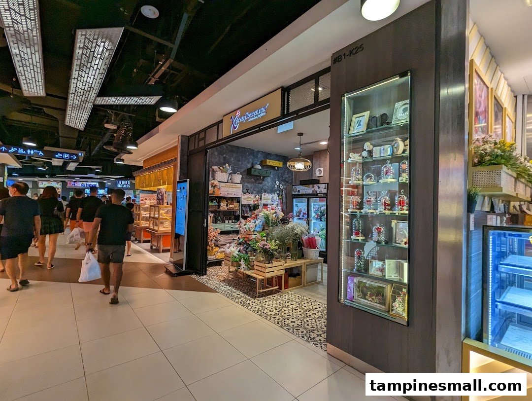 The shopfront of Xpressflower, a vibrant flower and gift shop, is seen within a busy shopping mall.