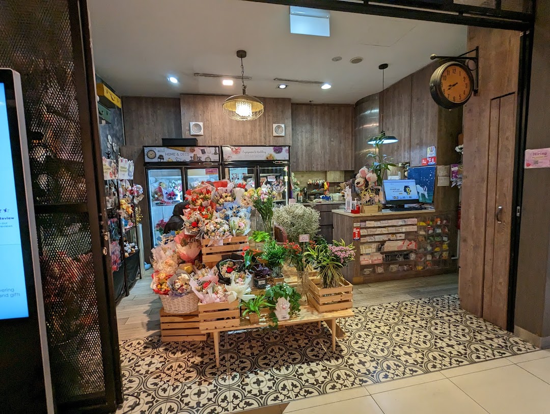 Interior view of Xpressflower, a vibrant shop displaying fresh floral arrangements, plants, and gifts.