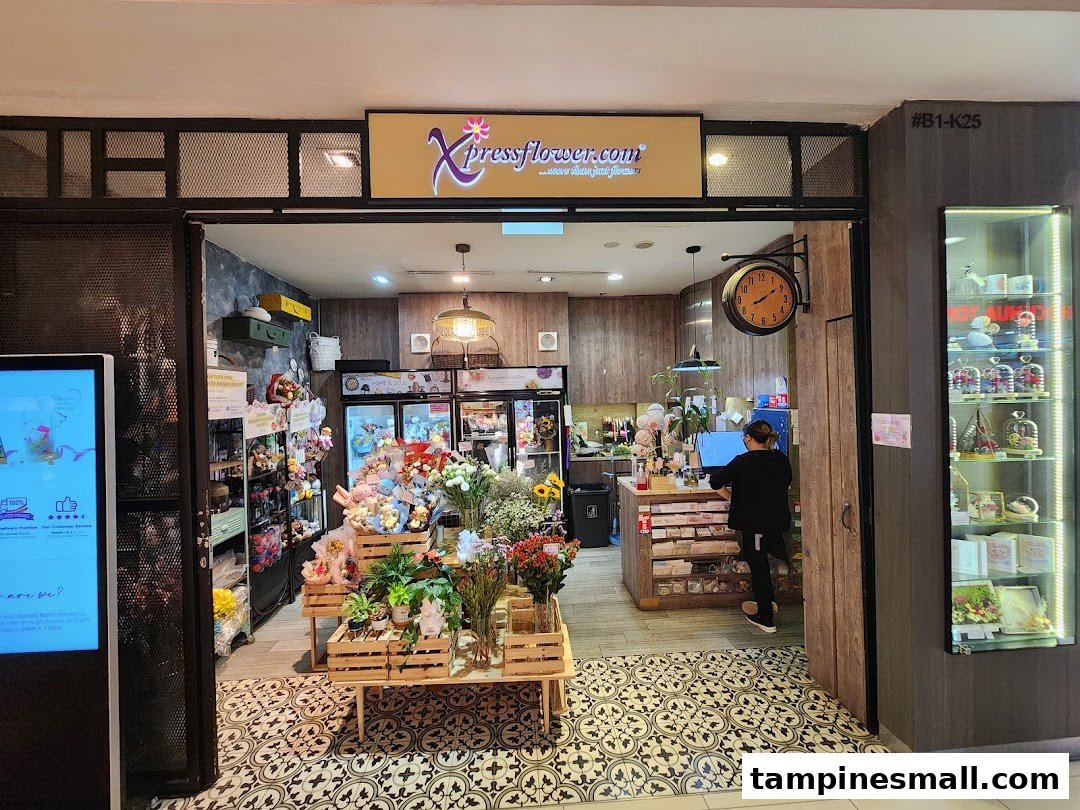 The Xpressflower shop entrance, showcasing fresh flowers, potted plants, and various gifts, with a staff member inside.