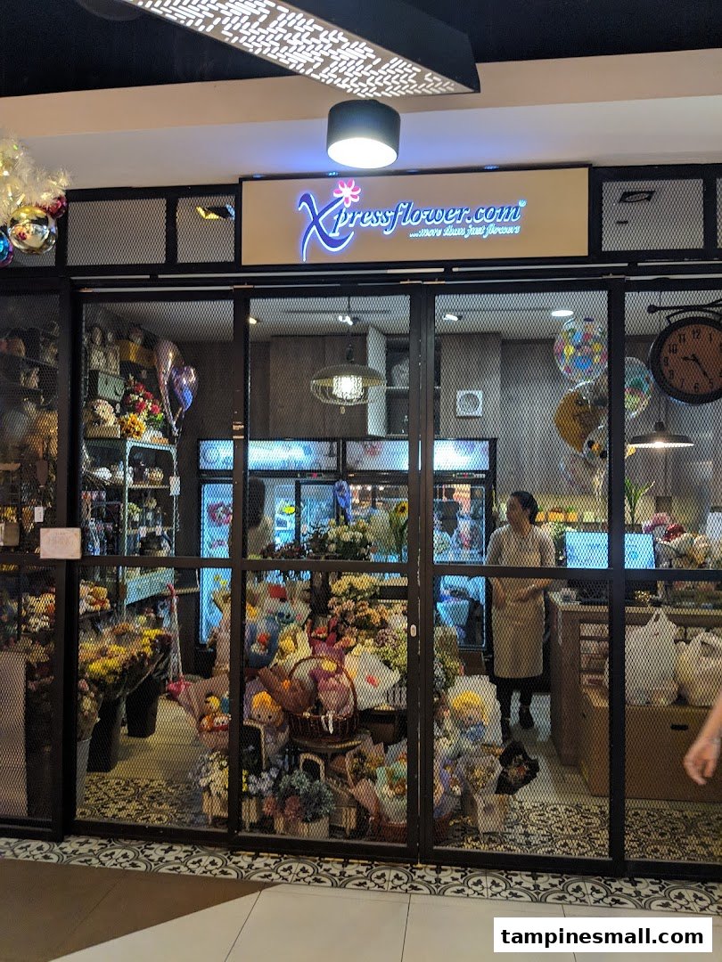 The storefront of Xpressflower, a vibrant flower and gift shop, showcasing colorful arrangements and balloons.