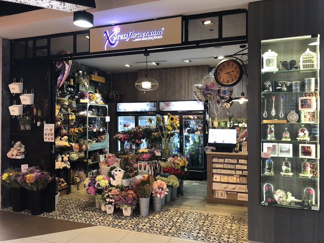 The vibrant entrance of Xpressflower, a floral shop, showcasing a wide array of flowers and gifts.