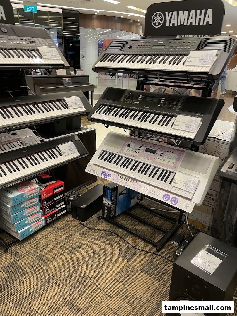 Interior view of Yamaha Music School showcasing a wide selection of digital pianos and keyboards.