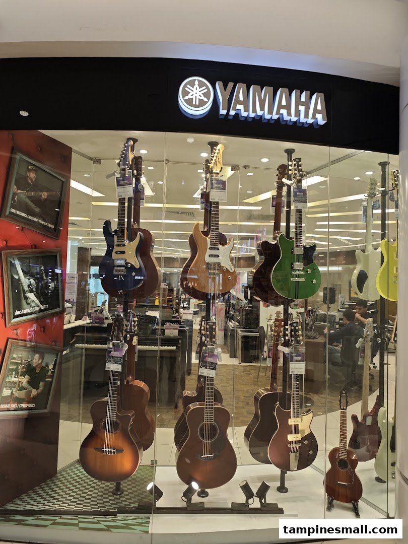 The shop front of Yamaha Music School featuring a display of various guitars and musical instruments.