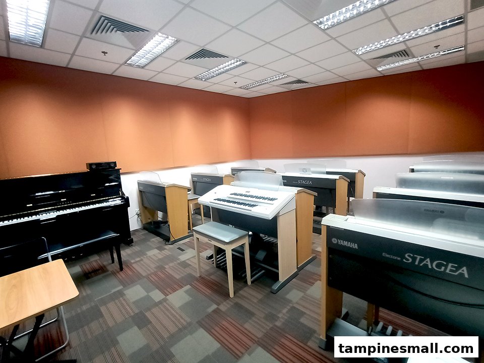 An interior view of a music classroom equipped with multiple Yamaha pianos and electronic organs.