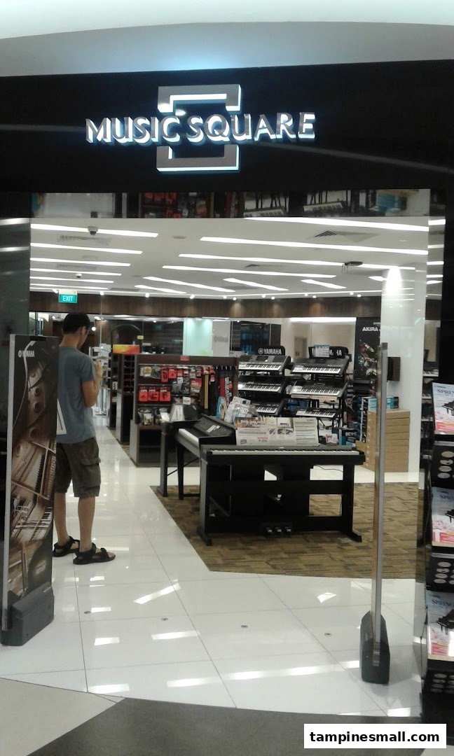 Entrance of Music Square, a music store, showcasing various instruments and a customer browsing.