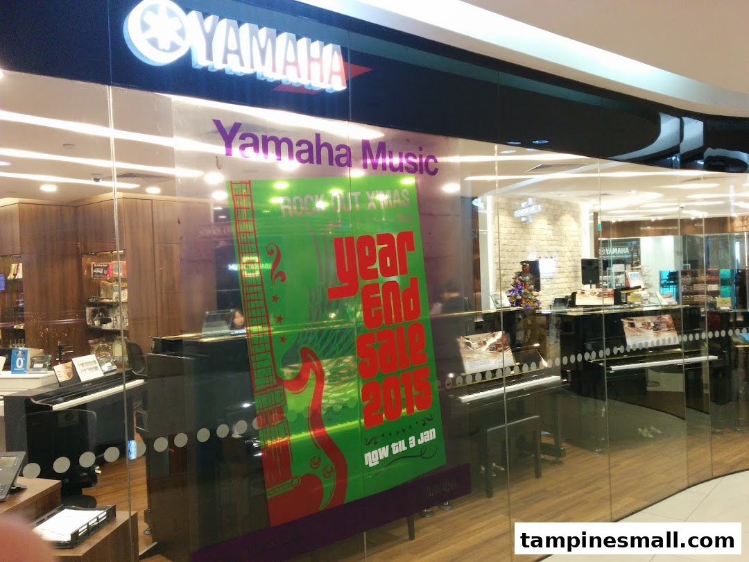 The Yamaha Music School shop front displays pianos, other instruments, and a 'Year End Sale' poster.