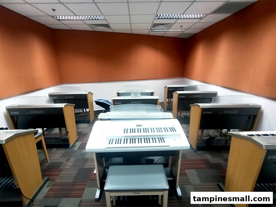 An interior view of a Yamaha Music School classroom filled with multiple electronic organs for music lessons.