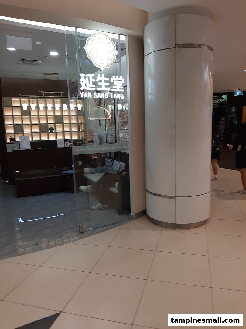 The glass entrance of Yan Sang Tang TCM Clinic, showcasing its logo and a glimpse of the inviting interior.