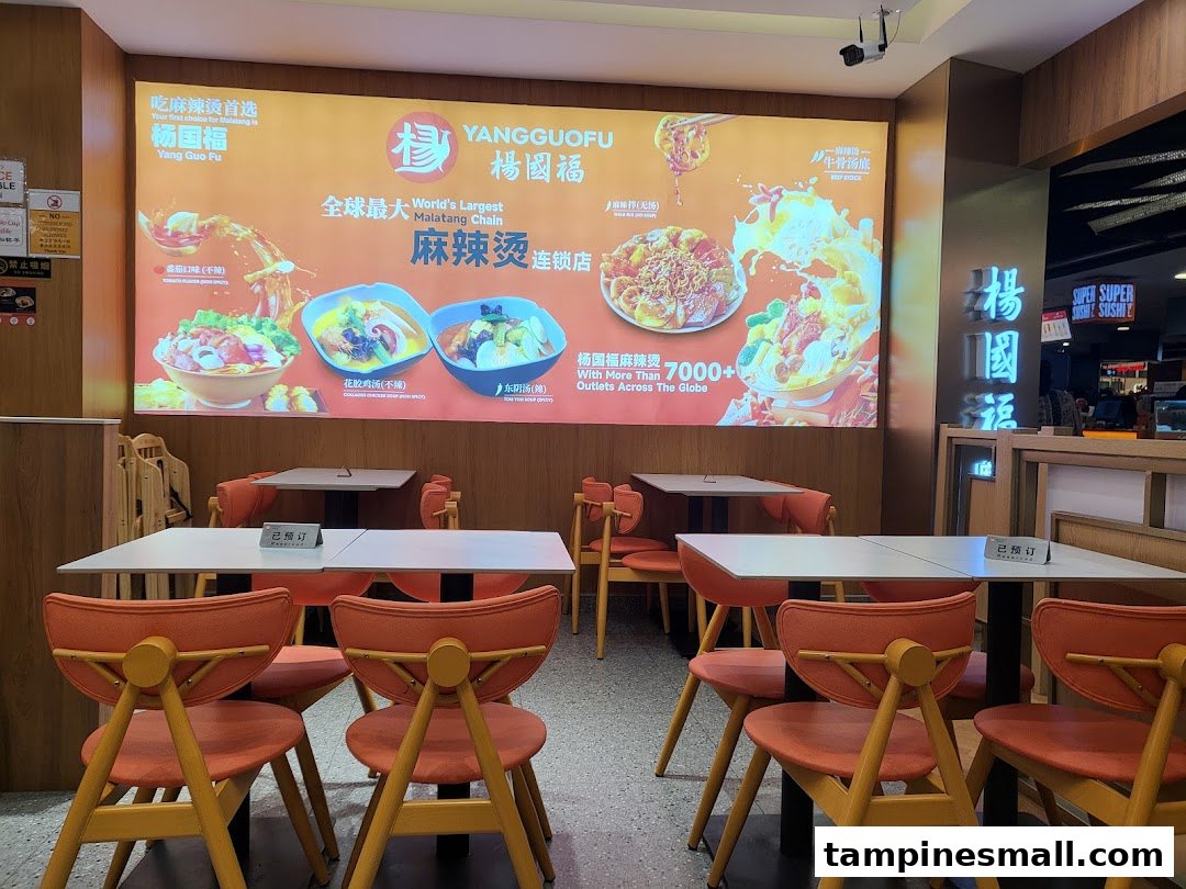 Interior of Yang Guo Fu Mala Tang, showcasing dining area and a large promotional wall display.