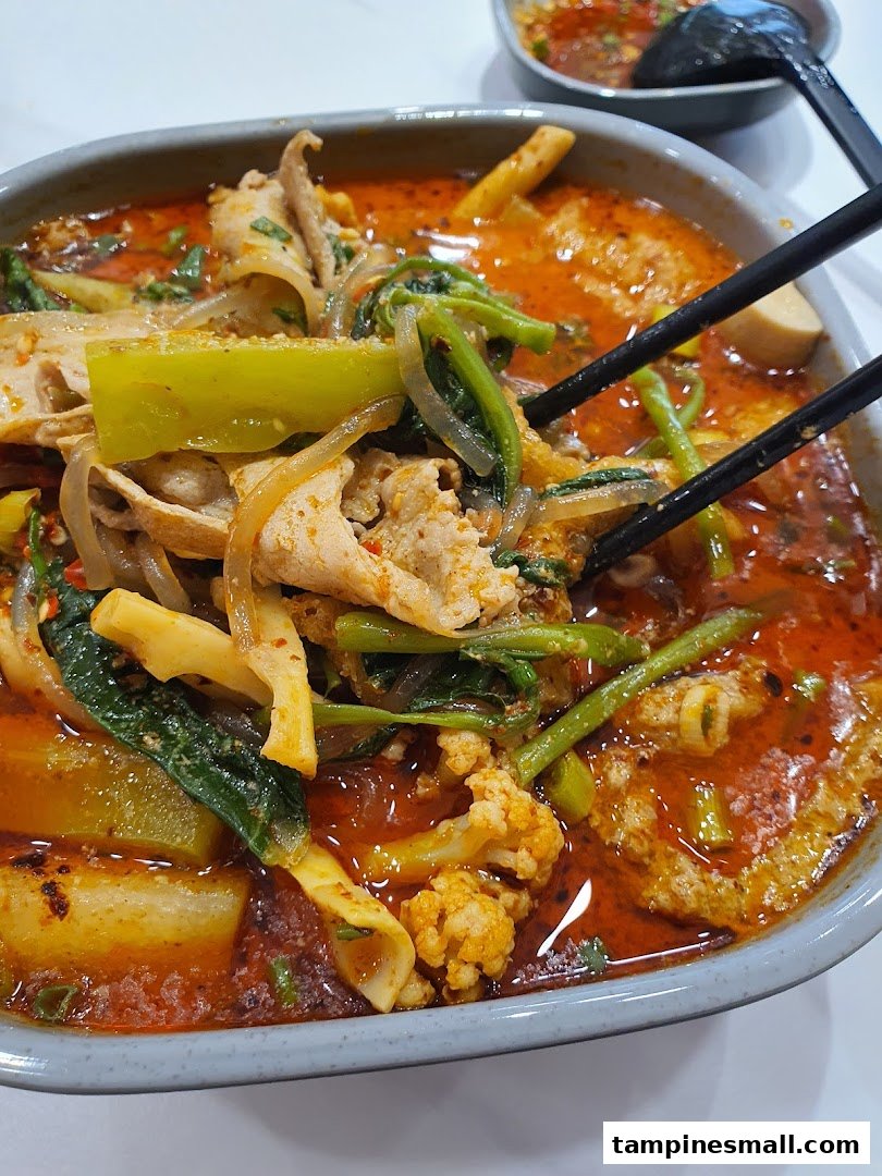 A close-up of a vibrant bowl of Mala Tang, featuring various ingredients in a spicy broth.
