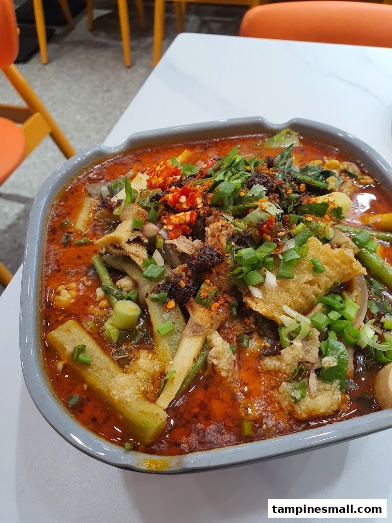 A vibrant bowl of spicy Mala Tang with various ingredients and fresh toppings.