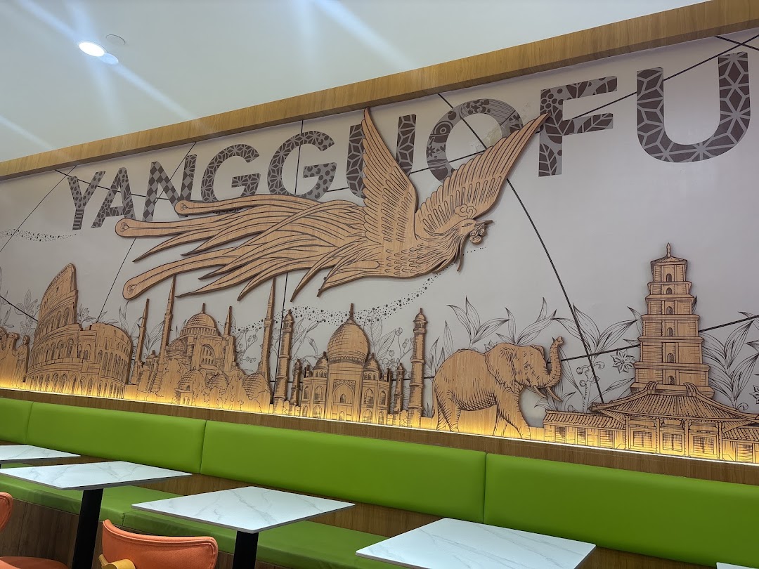Interior view of Yang Guo Fu Mala Tang featuring a large decorative wall mural and green booth seating.