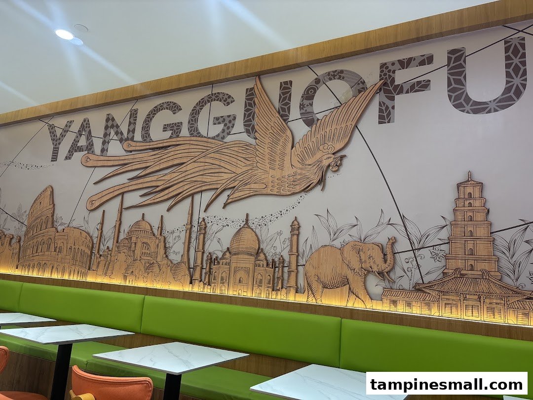 Interior view of Yang Guo Fu Mala Tang featuring a large decorative wall mural and green booth seating.