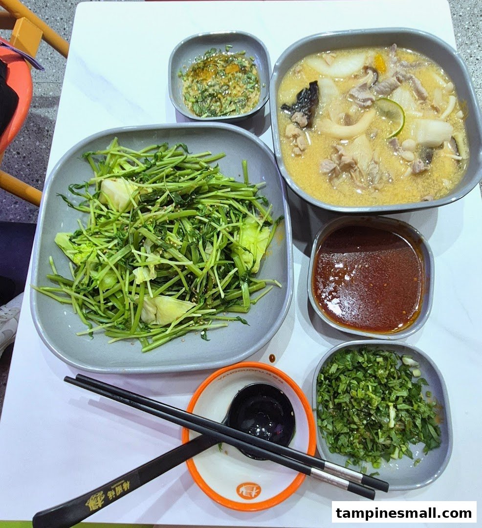 A table spread with various delicious dishes, including a hearty soup, fresh greens, and condiments.