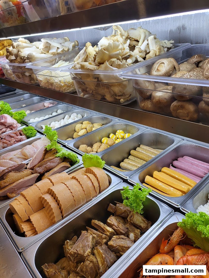 A vibrant display of fresh ingredients for customizable mala tang, including mushrooms, meats, seafood, and sausages.