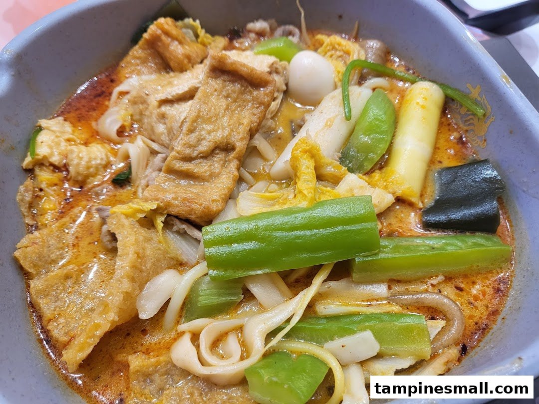 A close-up of a vibrant bowl of Mala Tang, featuring various ingredients in a rich, spicy broth.