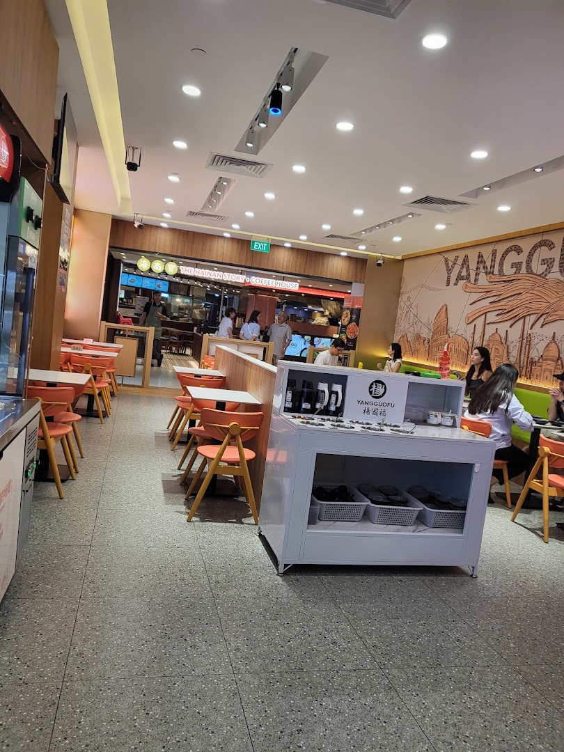Interior view of Yang Guo Fu Mala Tang, showing dining area, seating, and a self-serve station.