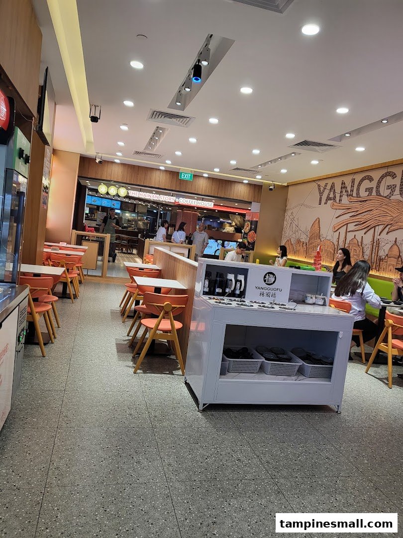 Interior view of Yang Guo Fu Mala Tang, showing dining area, seating, and a self-serve station.