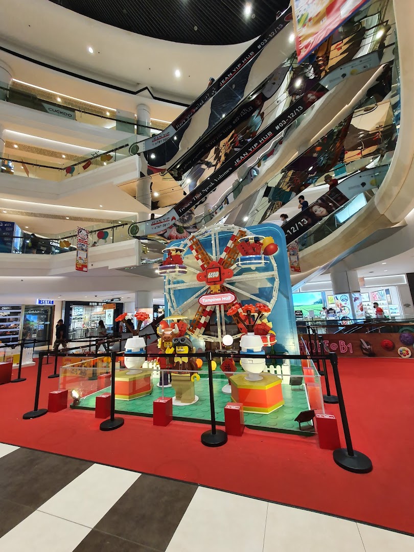 A vibrant LEGO display featuring a Ferris wheel in the multi-level atrium of Isetan Tampines mall.