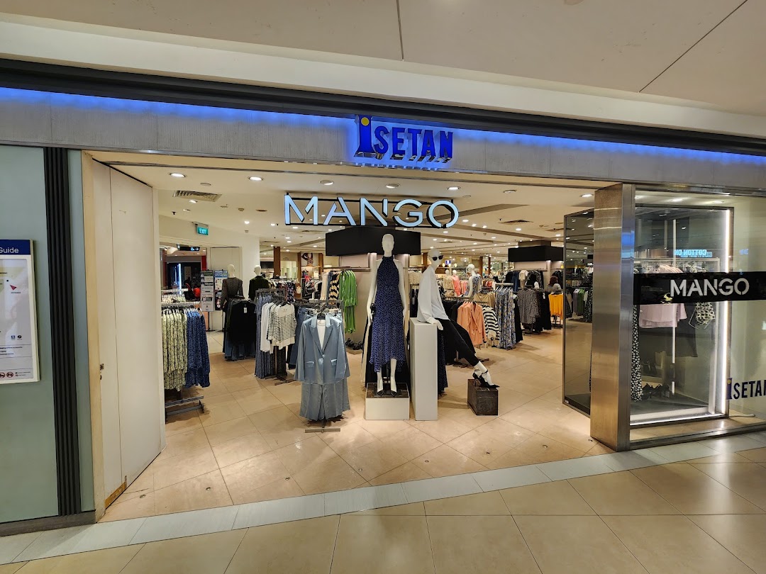 The entrance of a Mango fashion store within Isetan, showcasing trendy apparel and mannequins.