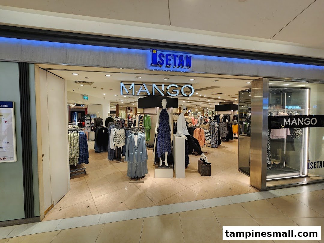 The entrance of a Mango fashion store within Isetan, showcasing trendy apparel and mannequins.