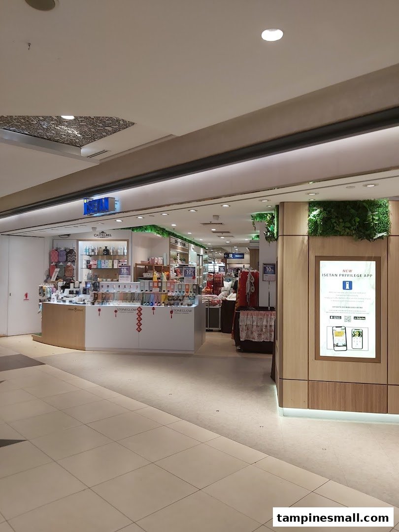 The entrance of Isetan Tampines, featuring a beauty counter and a digital display for their new privilege app.