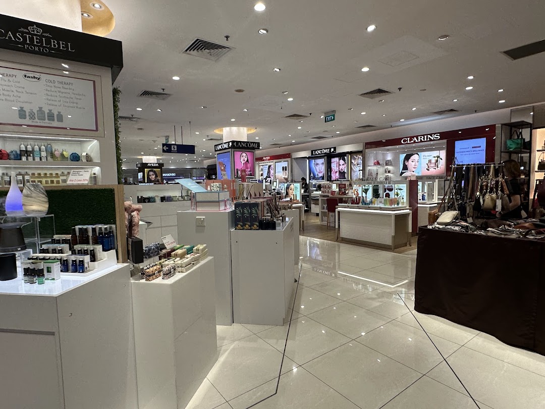 An interior view of a department store's beauty and wellness section featuring various cosmetic and skincare brands.