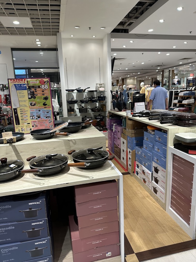 An interior view of a department store section displaying various cookware and kitchen items.