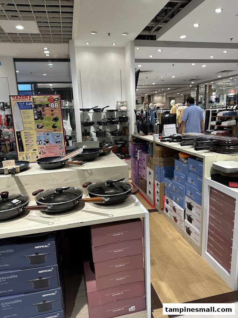 An interior view of a department store section displaying various cookware and kitchen items.