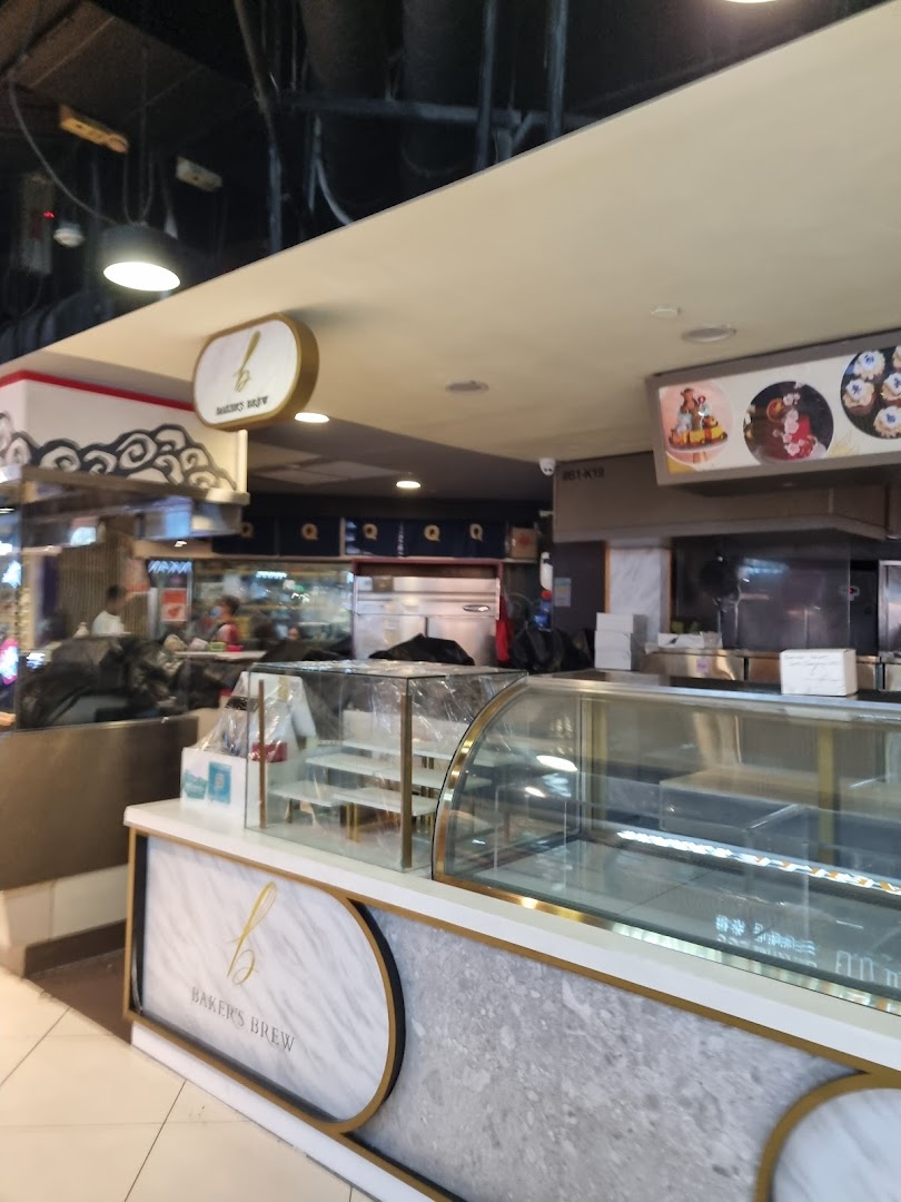 Interior view of Baker's Brew counter with empty display cases and prominent branding.