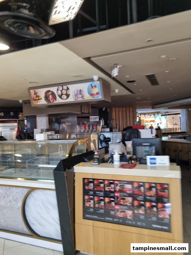 Interior view of Yolé at Tampines Mall, featuring the counter, display cases, and digital menu.