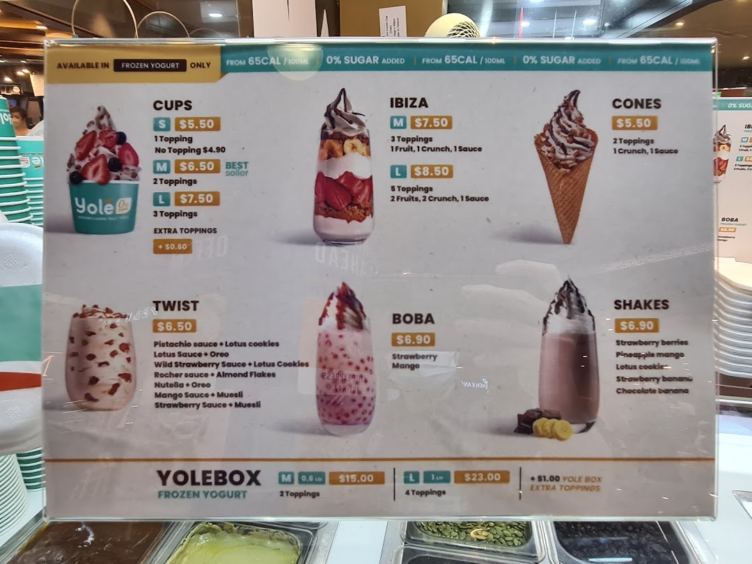 A detailed menu board displaying various frozen yogurt options, prices, and toppings at Yolé.