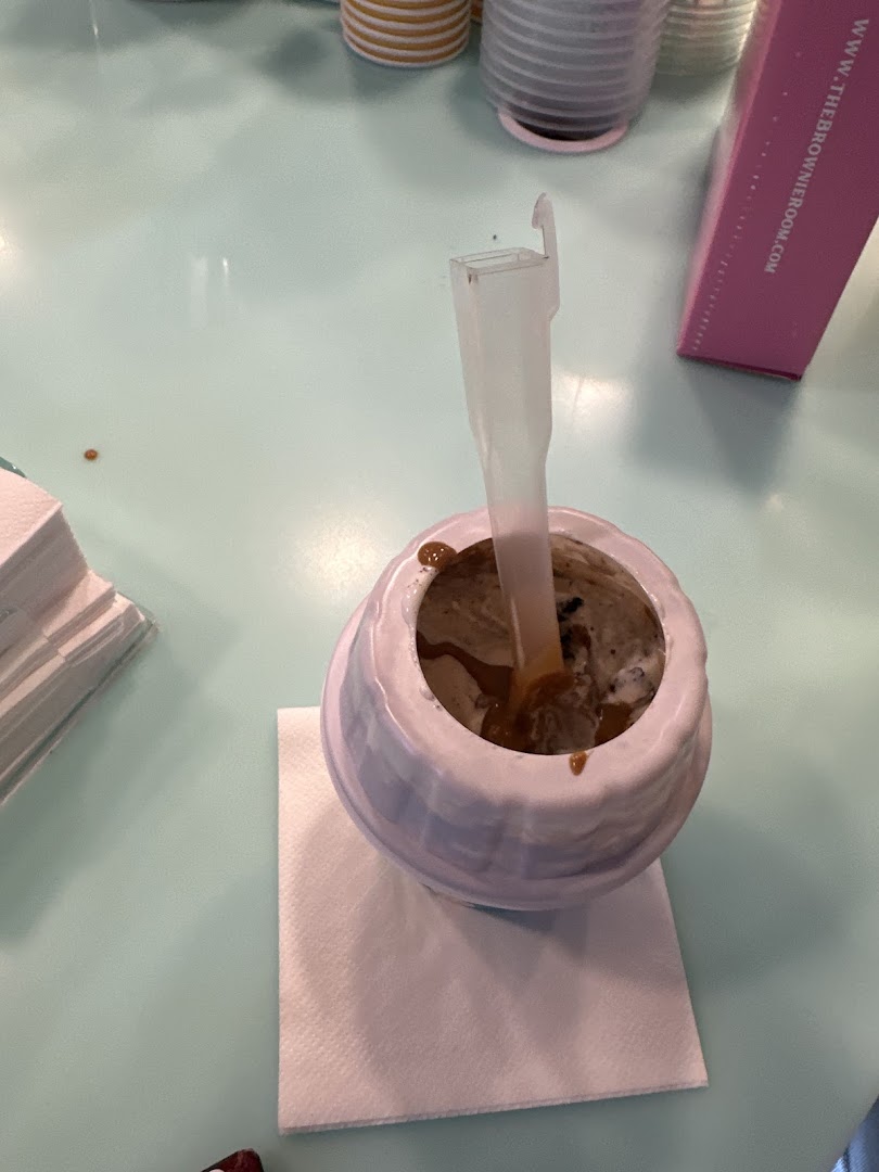 A close-up of a Yolé frozen yogurt dessert in a cup with a spoon.