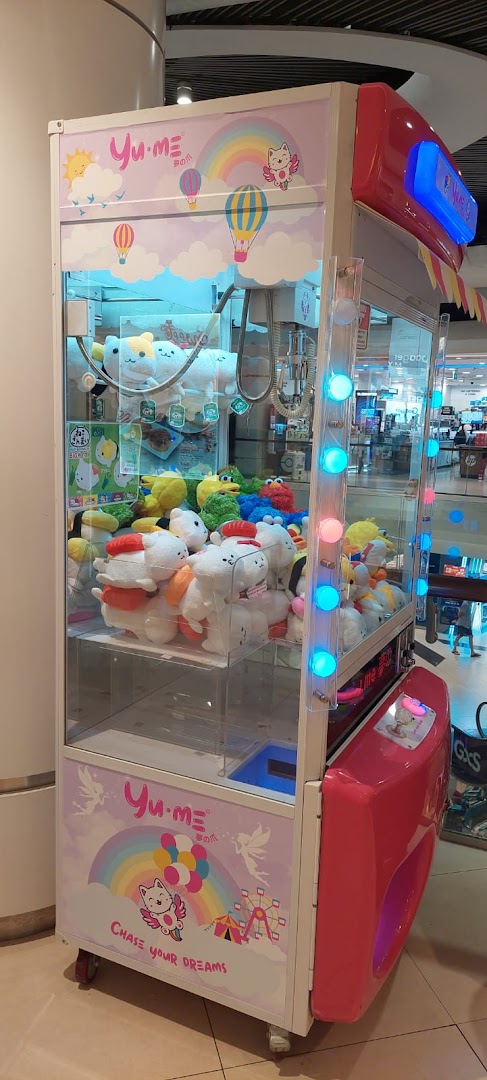 A vibrant Yume Claw machine filled with various cute plush toys, ready for players to win.