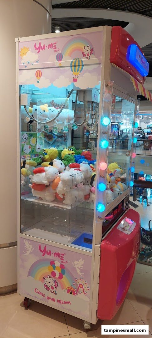 A vibrant Yume Claw machine filled with various cute plush toys, ready for players to win.