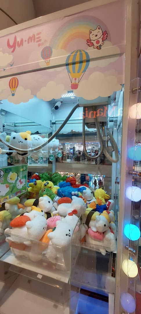 A vibrant claw machine filled with various plush toys, including sushi-themed and character plushies.