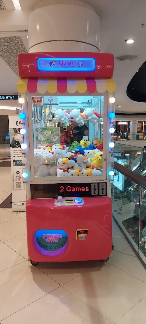 A vibrant pink Yume Claw machine filled with various cute plush toys, ready for play.