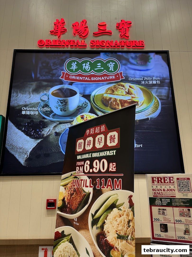 A display board for Oriental Kopi featuring breakfast deals and menu items like coffee and polo buns.