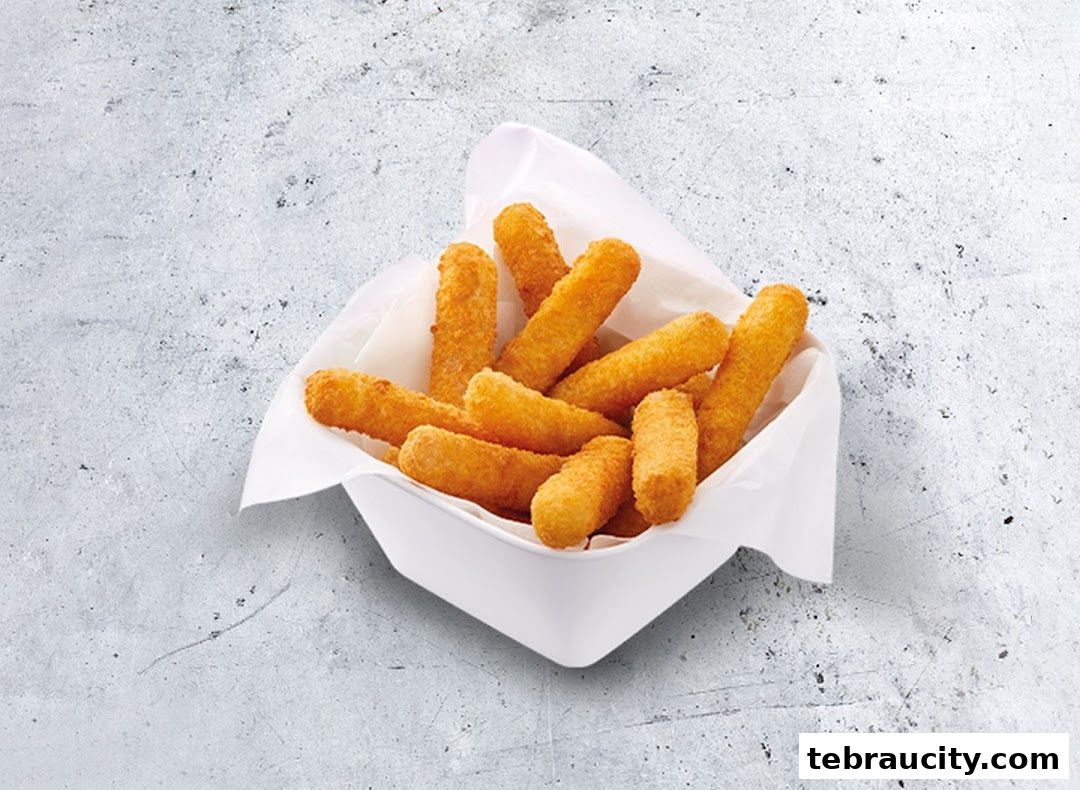 A white bowl filled with golden-brown mozzarella sticks on a textured grey surface.