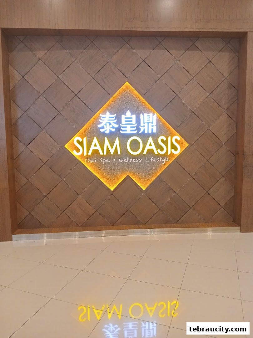 The illuminated sign for Siam Oasis, a Thai Spa and wellness lifestyle brand.