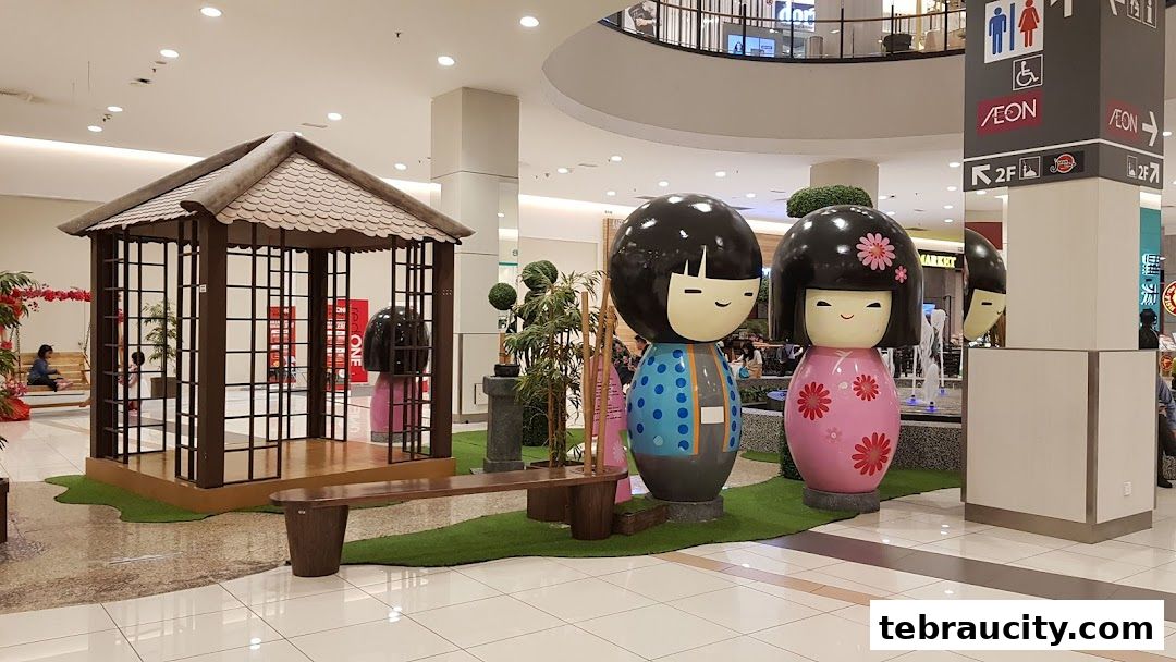 Giant Kokeshi dolls and a Japanese-style gazebo are displayed in a shopping mall.