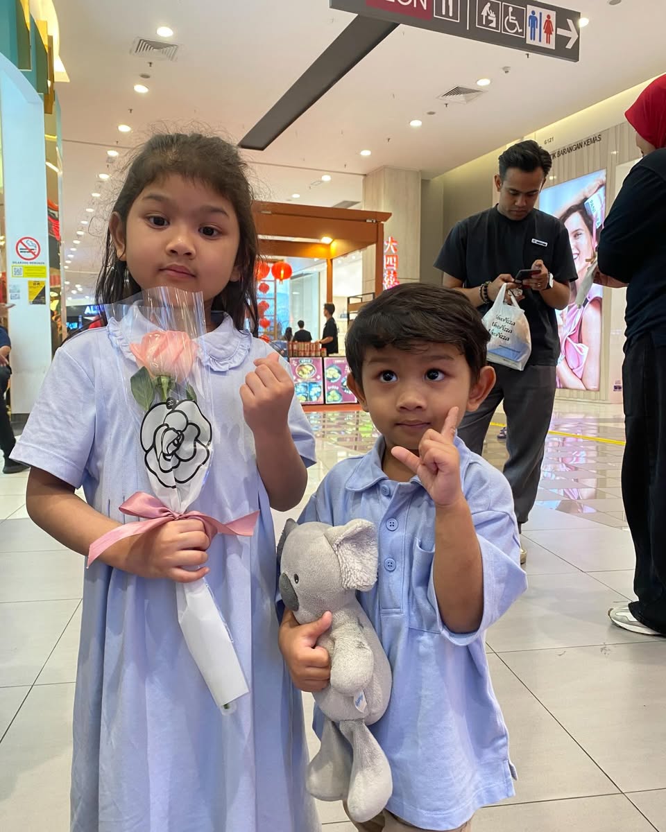 Shoppers smiling while receiving their free Valentine's Day roses