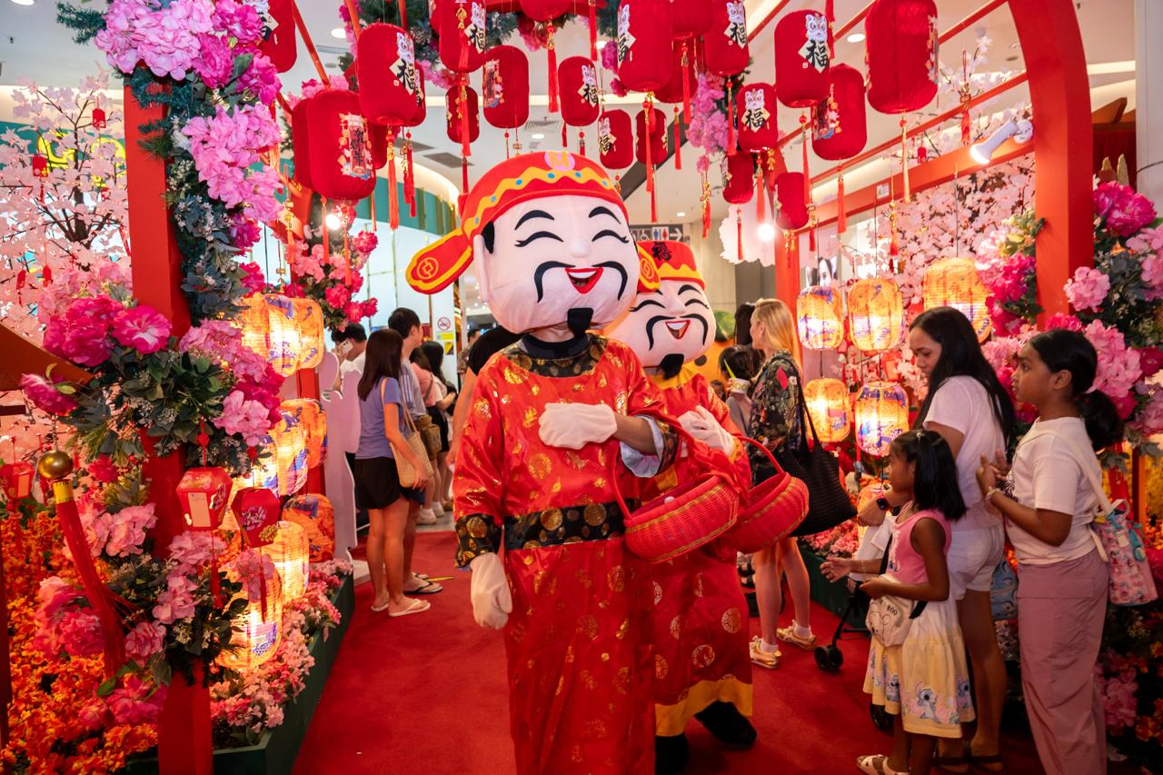 Colorful decorations and orange-themed displays at AEON Mall Tebrau City.