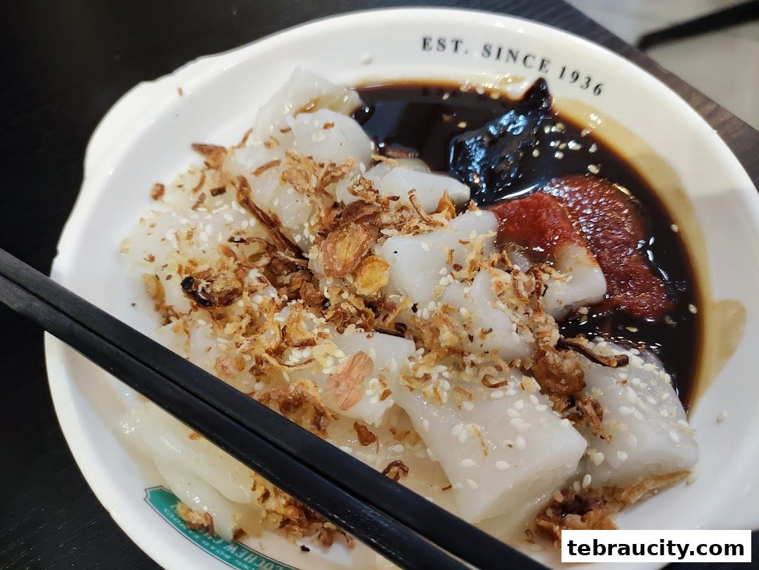 A close-up of Chendul dessert with rice noodles, coconut milk, palm sugar, and toppings.