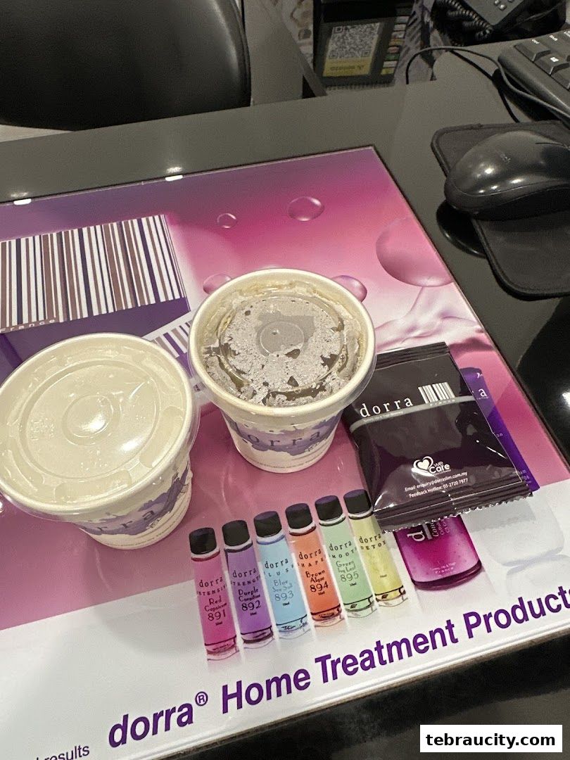Two cups of drinks and several small bottles of slimming products are displayed on a desk.