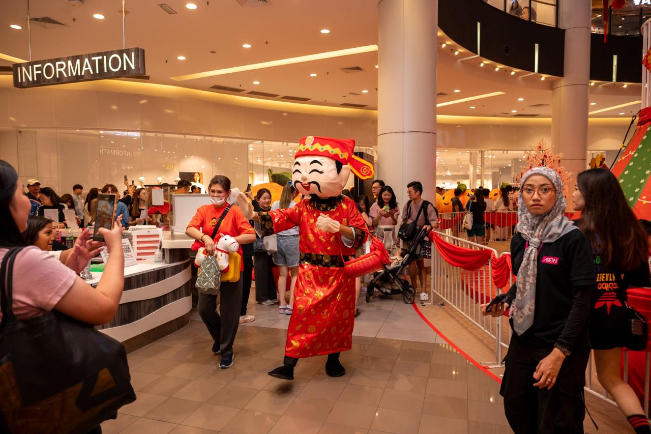 A vibrant crowd participating in the Orange Parade festivities.