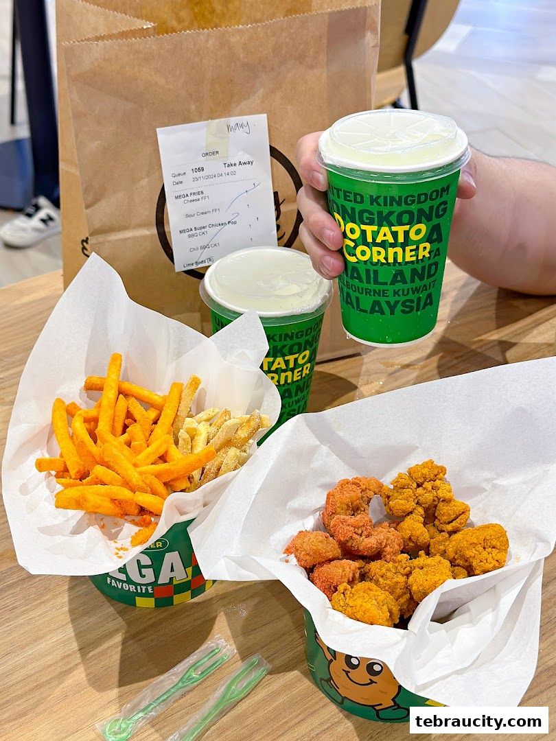 A spread of Potato Corner fries and chicken pops with drinks and a receipt.